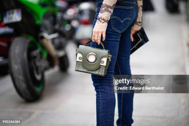 Camila Coutinho wears a blue denim corset, a lace mesh top with embroidered flowers, blue denim jeans, outside Jean-Paul Gaultier, during Paris...