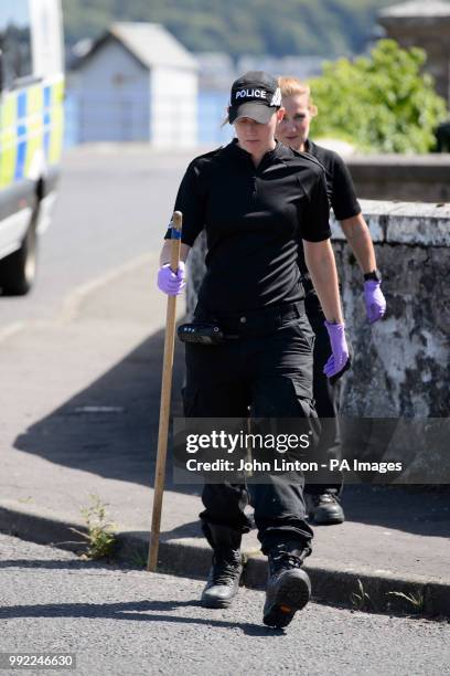 Police searching streets and houses in Ardbeg Road on the Isle of Bute in Scotland, after the body of Alesha MacPhail was found in woodland on the...