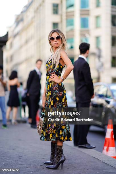 Erica Pelosini wears a mesh lace dress with colored printings, boots, sunglasses, outside Fendi, during Paris Fashion Week Haute Couture Fall Winter...