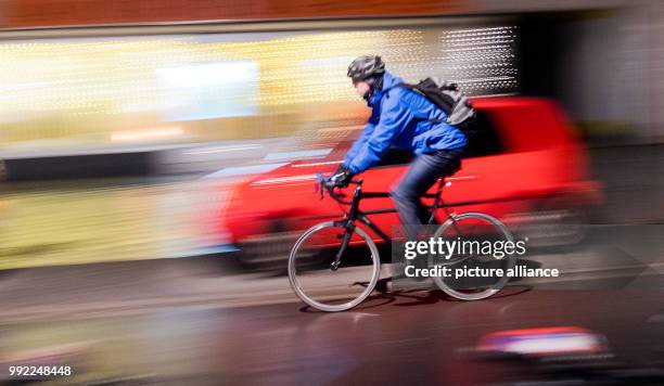 Cyclist drives across a cycling path in Hanover, Germany, 27 November 2017. The General German Automobile Club examined city resident's satisfaction...