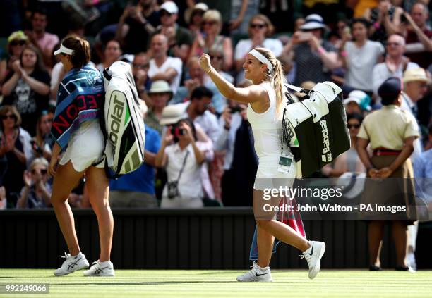 Johanna Konta walks off court as Dominika Cibulkova celebrates after their match on day four of the Wimbledon Championships at the All England Lawn...