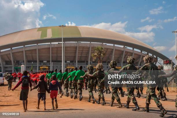 Malawi children follow defence force soldiers during a memorial parade on July 5 marching through Mtandile on their way to Bingu National Stadium,...