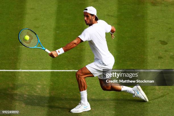 Feliciano Lopez of Spain returns a shot against Juan Martin del Potro of Argentina during their Men's Singles second round match on day four of the...