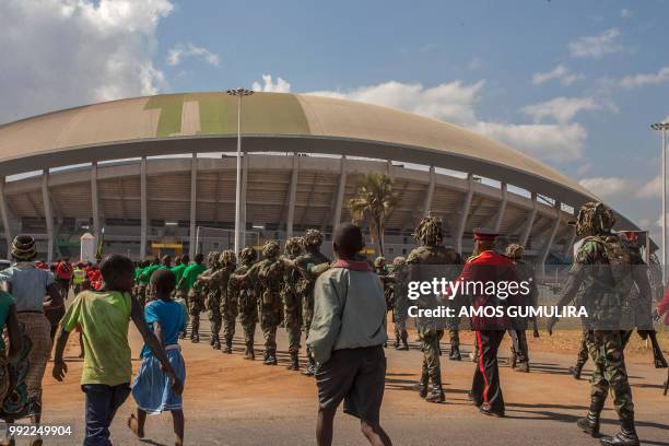 Malawi children follow defence force soldiers during a memorial parade on July 5 marching through Mtandile on their way to Bingu National Stadium,...