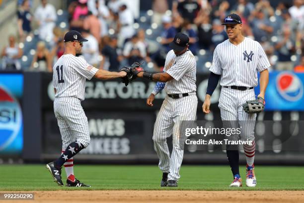 Brett Gardner, Aaron Hicks, and Aaron Judge of the New York Yankees celebrate after defeating the Atlanta Braves 6-2 during a game at Yankee Stadium...