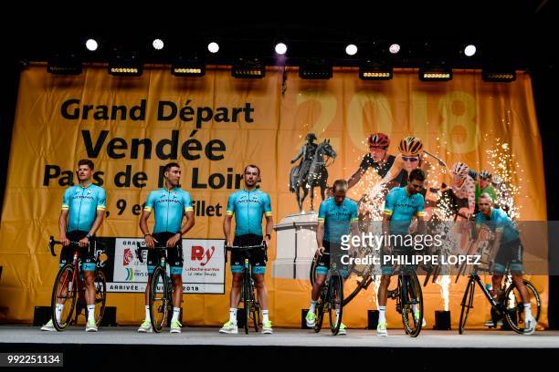 Riders of Kazakhstan's Astana Pro cycling team stand on stage during the team presentation ceremony on July 5, 2018 in La Roche-sur-Yon, western...