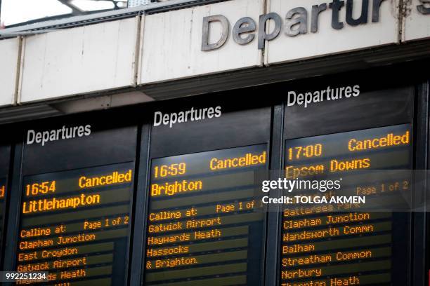 Departure boards at London's Victoria railway station display a list of cancelled trains on July 5 after an electrical supply problem in south London...