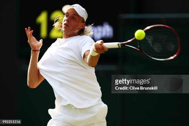Denis Shapovalov of Canada returns a shot against Benoit Paire of France during their Men's Singles second round match on day four of the Wimbledon...