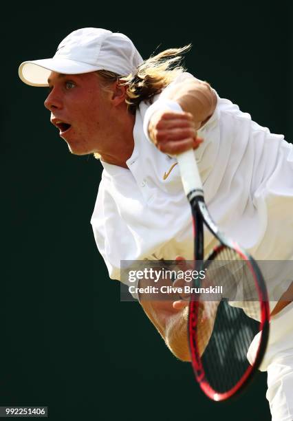 Denis Shapovalov of Canada serves against Benoit Paire of France during their Men's Singles second round match on day four of the Wimbledon Lawn...