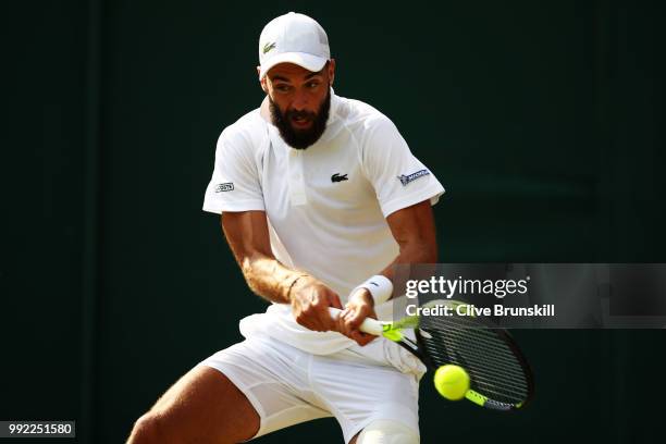 Benoit Paire of France returns a shot against Denis Shapovalov of Canada during their Men's Singles second round match on day four of the Wimbledon...