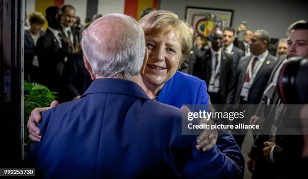 Germany's Chancellor Angela Merkel greets Beji Caid el Sebsi, President of Tunisia, with a hug for his 91st birthday at the Africa-EU summit in...