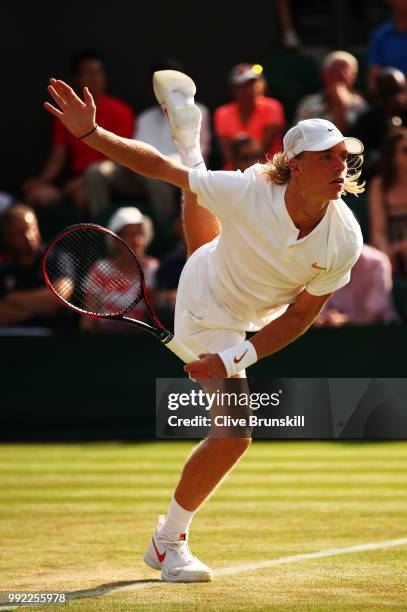 Denis Shapovalov of Canada serves against Benoit Paire of France during their Men's Singles second round match on day four of the Wimbledon Lawn...