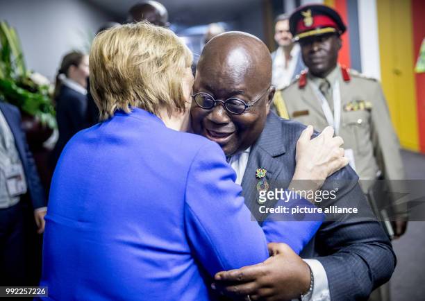 Germany's Chancellor Angela Merkel greets Ghanaian President, Nana Akufo-Addo, during the African Union-European Union summit, in Abidjan, Ivory...