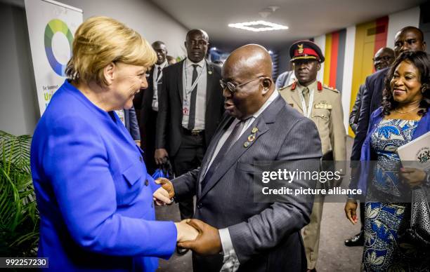 Germany's Chancellor Angela Merkel greets Ghanaian President, Nana Akufo-Addo, during the African Union-European Union summit, in Abidjan, Ivory...