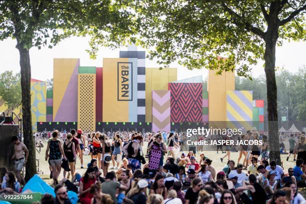 People attend the first day of the Rock Werchter music festival in Werchter, on July 5, 2018. - The 43rd edition of the festival is taking place from...