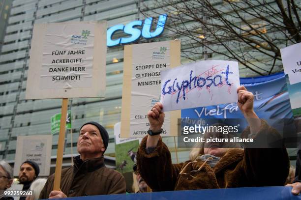 Activists hold up signs with phrases like 'Glyphosat Nein' or 'Fuenf Jahre Ackergift: Danke Herr Schmidt!' during a demonstration organised by...