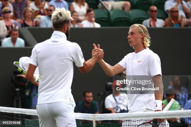 Benoit Paire of France shakes hands with Denis Shapovalov of Canada after their Men's Singles second round match on day four of the Wimbledon Lawn...