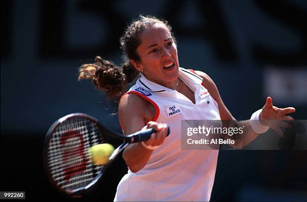 Sandrine Testud of France returns in her fourth round match against Martina Hingis of Switzerland losing 6/1 2/6 6/2 during the French Open Tennis at...