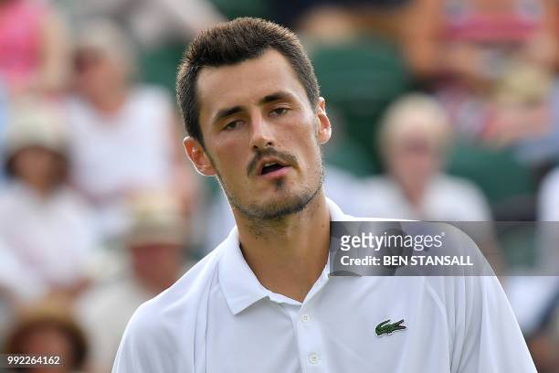 Australia's Bernard Tomic reacts against Japan's Kei Nishikori during their men's singles second round match on the fourth day of the 2018 Wimbledon...