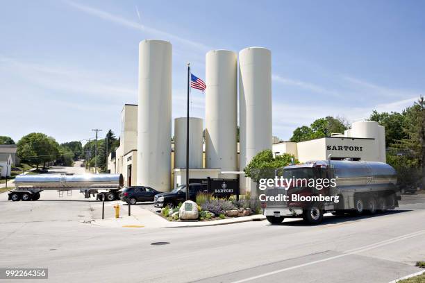 Milk tanker trucks drive outside the Sartori Co. Cheese production facility in Plymouth, Wisconsin, U.S., on Tuesday, July 3, 2018. Dairy has also...