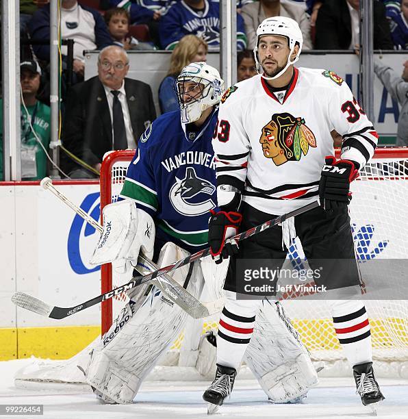 Dustin Byfuglien of the Chicago Blackhawks stands in front of Roberto Luongo of the Vancouver Canucks in Game 6 of the Western Conference Semifinals...