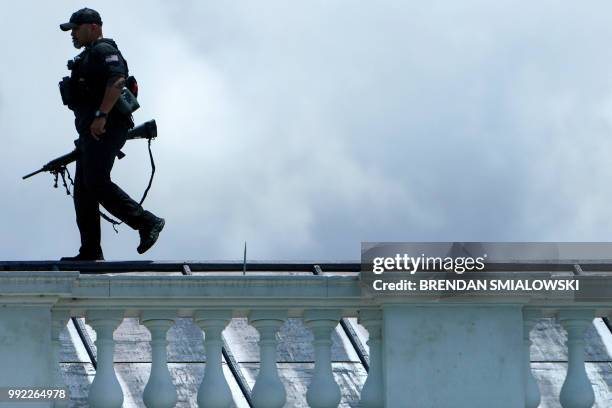 Secret Service sniper walks on top of the North Portico of the White House on July 5, 2018 in Washington, DC.