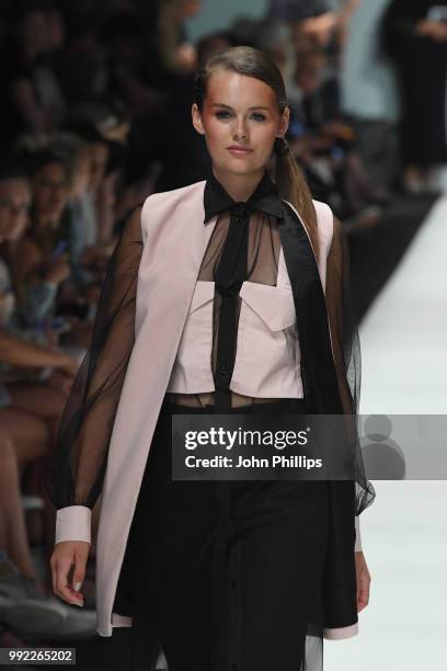 Wearing the collection of Andrea Bou, a model walks the runway at the Rebelpin - Fashion Awards By Acte show during the Berlin Fashion Week...