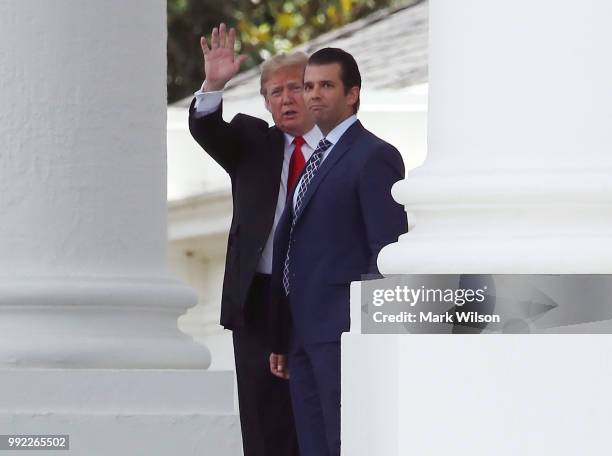 President Donald Trump and his son Donald Trump Jr. Walk out onto the North Portico of the White House while departing on a trip to Wyoming to attend...