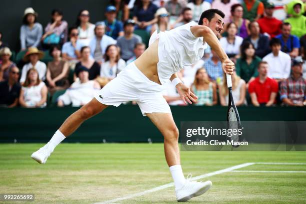 Bernard Tomic of Australia serves against Kei Nishikori of Japan during their Men's Singles second round match on day four of the Wimbledon Lawn...