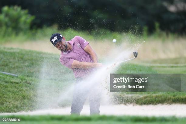 Ryan Moore hits out of the bunker on the 17th hole during round one of A Military Tribute At The Greenbrier held at the Old White TPC course on July...