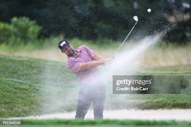 Ryan Moore hits out of the bunker on the 17th hole during round one of A Military Tribute At The Greenbrier held at the Old White TPC course on July...