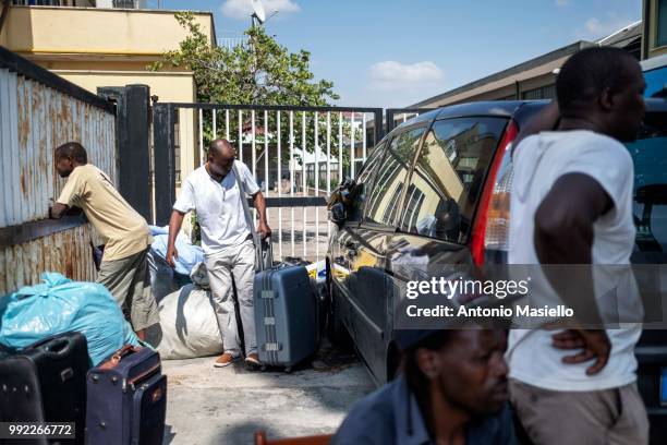 Migrants and refugees stay outside a building after being evicted by Italian Police on July 5, 2018 in Rome, Italy. About 120 African migrants were...