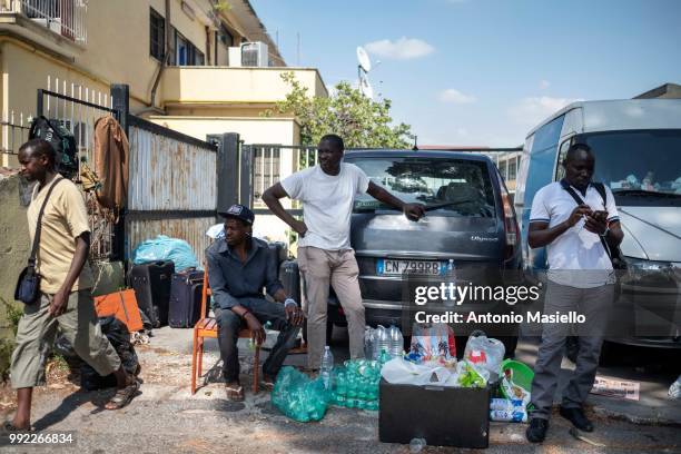 Migrants and refugees stay outside a building after being evicted by Italian Police on July 5, 2018 in Rome, Italy. About 120 African migrants were...