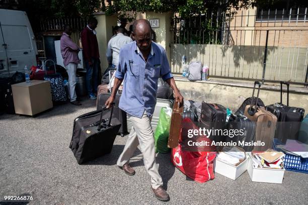 Migrants and refugees stay outside a building after being evicted by Italian Police on July 5, 2018 in Rome, Italy. About 120 African migrants were...