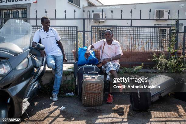 Migrants and refugees stay outside a building after being evicted by Italian Police on July 5, 2018 in Rome, Italy. About 120 African migrants were...