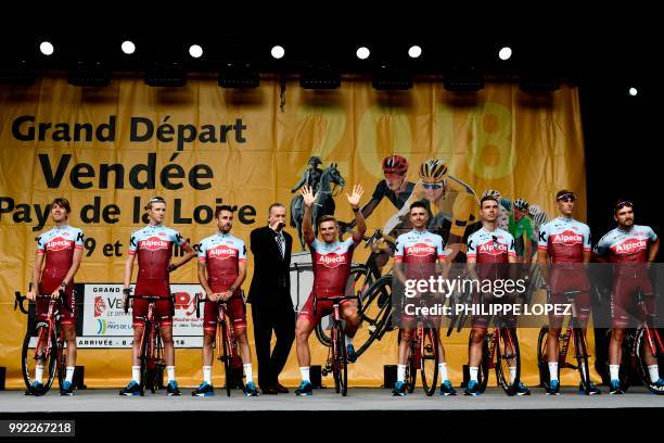 Germany's Marcel Kittel waves as riders of Switzerland's Katusha Alpecin cycling team stand on stage during the team presentation ceremony on July 5,...