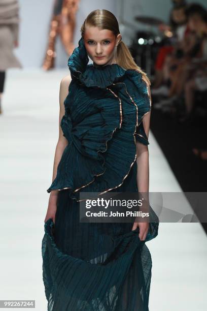 Wearing the collection of Anastasiya Stepanenko, a model walks the runway at the Rebelpin - Fashion Awards By Acte show during the Berlin Fashion...