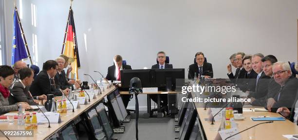German Minister of the Interior Thomas de Maizière sitting between the President of the Federal Criminal Office , Holger Munch , and the...