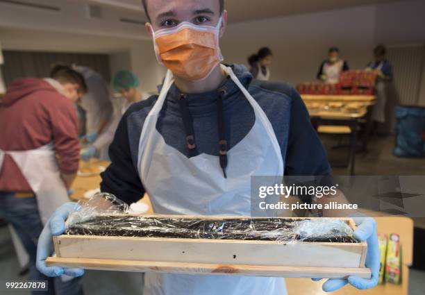 Vladislaw, a student at the Philipp Reis School in Berlin's Lichtenberg, helping in the production of a giant hedgehog slice in Berlin, Germany, 30...