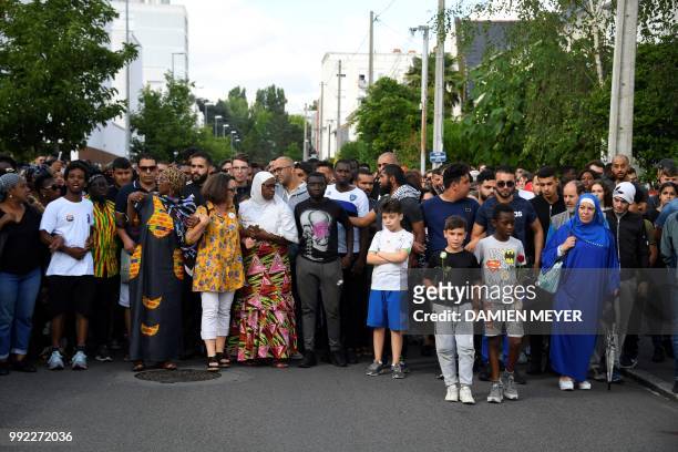 People gather for a commemorative march at the site where a man who was shot dead by an officer during a police check in the Breil neighborhood of...