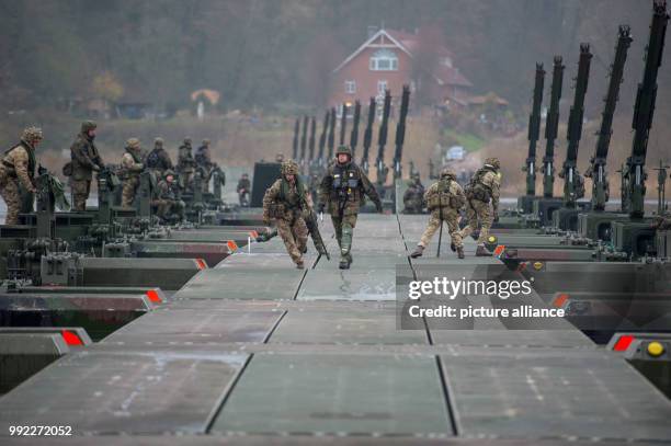 German and British soldiers setting up a bridge over the river Elbe with use of M3 Amphibious rigs in Artlenburg, Germany, 30 November 2017. Several...