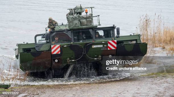 German M3 Amphibious rig emerges from the river Elbe during a military exercise involving German and British soldiers to set up a pontoon bridge in...