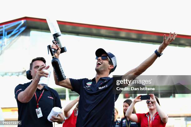 Daniel Ricciardo of Australia and Red Bull Racing fires tshirts into the crowd during previews ahead of the Formula One Grand Prix of Great Britain...