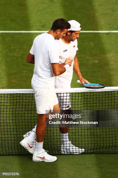 Juan Martin del Potro of Argentina shakes hands with Feliciano Lopez of Spain afyt their Men's Singles second round match on day four of the...