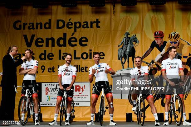 Netherlands' Koen de Kort gestures as riders of USA's Trek - Segafredo cycling team stand on stage during the team presentation ceremony on July 5,...