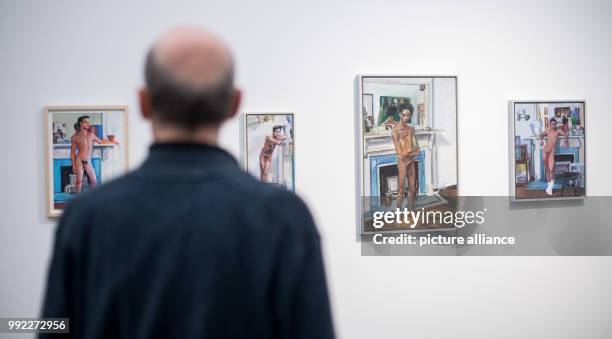 Visitor stands in front of different paintings during a press preview of the exhibition 'Patrick Angus. Private Show' at the Kunstmuseum in...