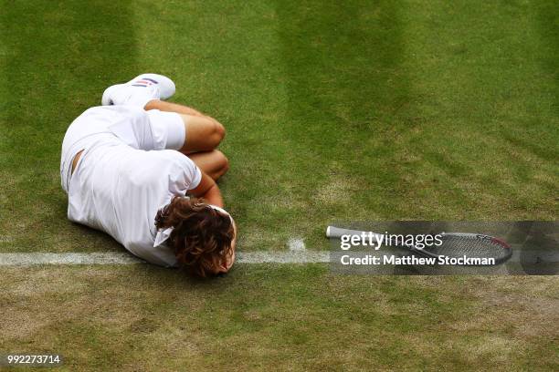 Alexander Zverev of Germany lays on the ground after an attempt on a return against Taylor Fritz of the United States duirng their Men's Singles...