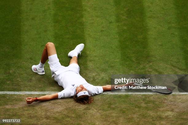 Alexander Zverev of Germany lays on the ground after an attempt on a return against Taylor Fritz of the United States duirng their Men's Singles...