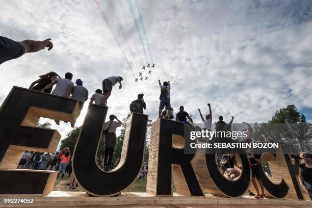 French AlphaJets of the Patrouille de France fly over an 'Eurocks' sign during the 30th Eurockeennes rock music festival on July 5, 2018 in Belfort,...
