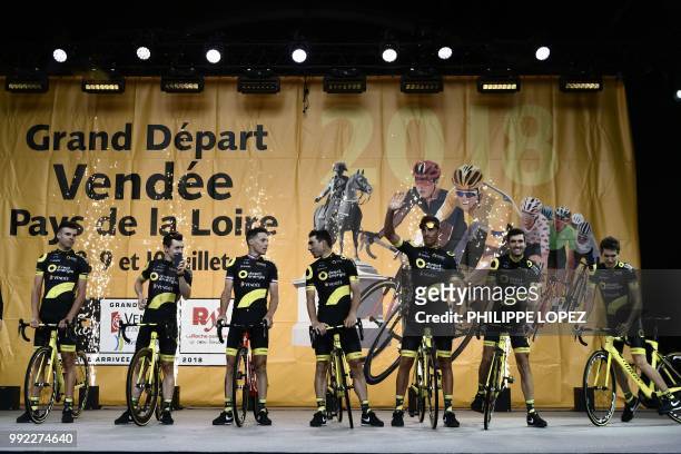 France's Lilian Calmejane and riders of France's Direct Energie cycling team pose on stage during the team presentation ceremony on July 5, 2018 in...